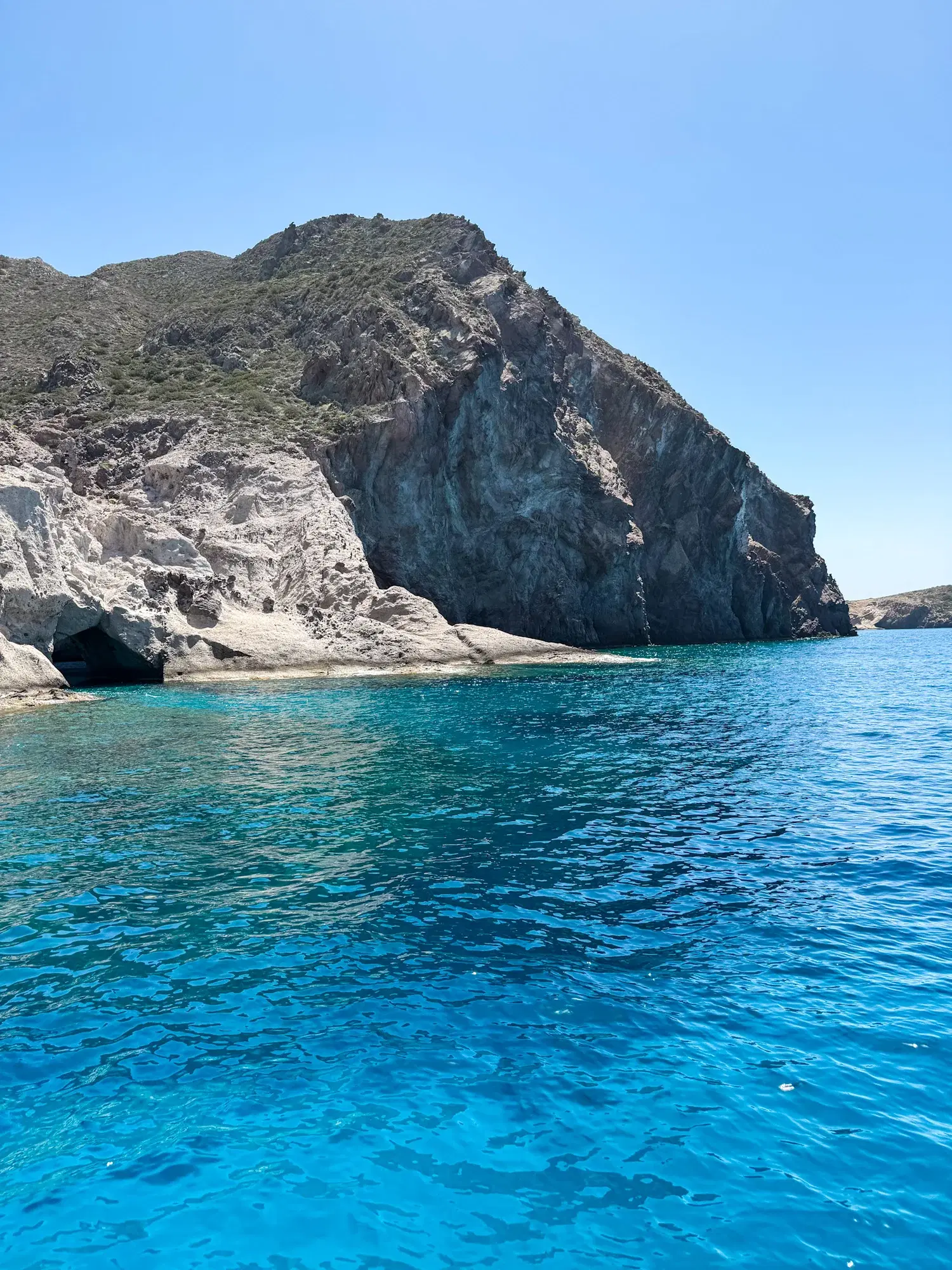 Boat in clear shallow water near the shore in Paros