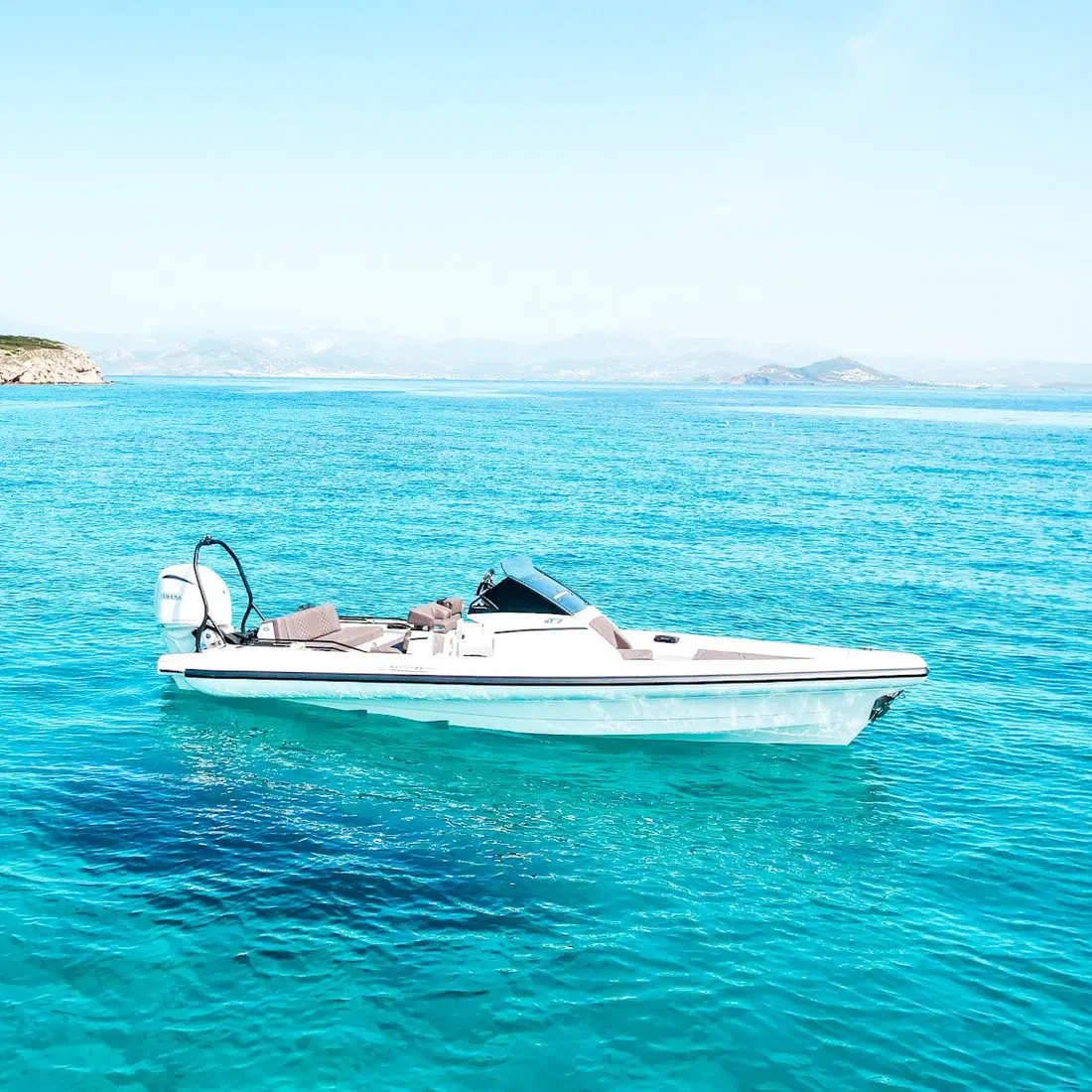 Private charter boat cruising on the Aegean sea in Paros